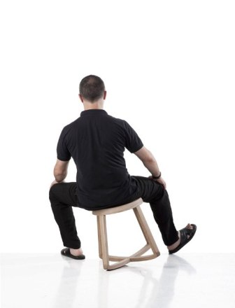 Man Sitting On A Wobbly Stool