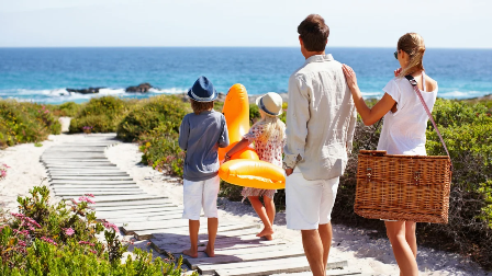 Mom Dad And Children Going To The Beach Together  The Girl Carrying An Inflatable Rubber Duck For Swimming