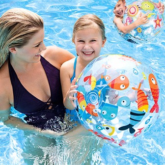 Mom With A Happy Child Holding A Beach Ball In A Swimming Pool